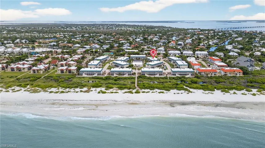 Aerial perspective of suburban area featuring expansive beach