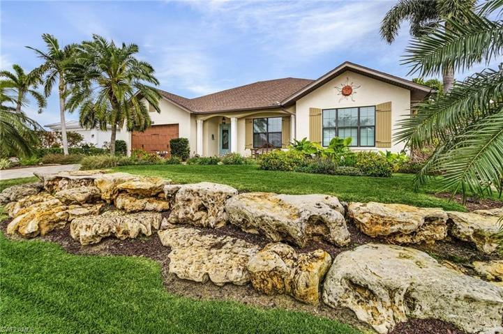 Street view with professionally landscaped lawn.