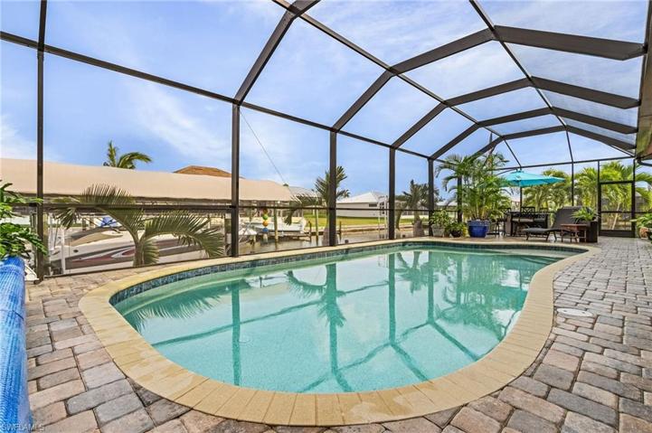 New pool pump & heater (2024), no-see-um "20/20" screened pool cage (2023), outdoor shower, pool bath, lanai tv & speakers.