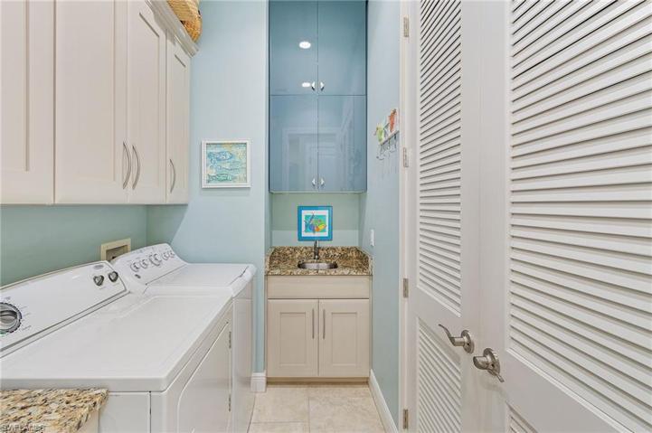 Laundry room with sink and pantry.