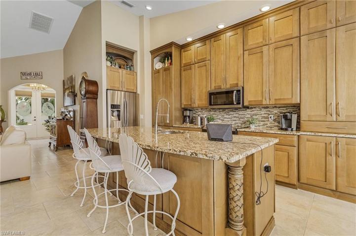 Custom kitchen with plenty of cabinet space, stainless appliances, and granite.