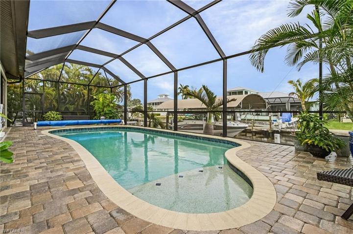 Custom pool with sun shelf and pavered pool deck.