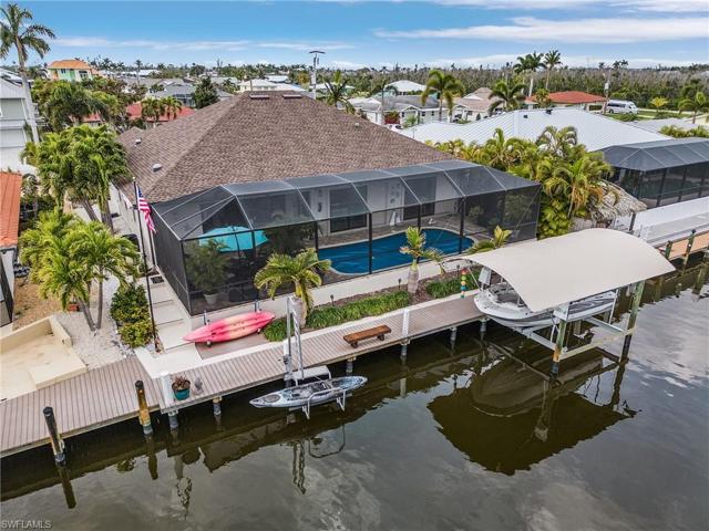 Composite dock with covered, remote boat lift,  and kayak lift.