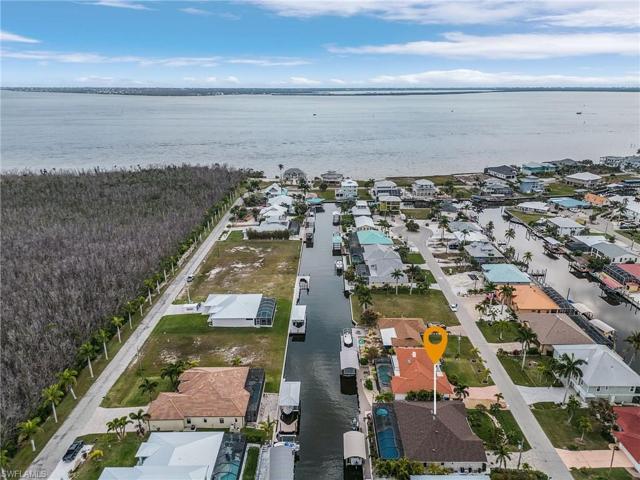 Aerial of home looking south toward the ICW and Sanibel with the Gulf of Mexico in the background.  This home has very quick access to all the Outer Islands of Lee County.