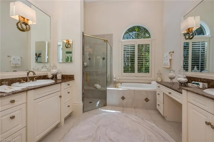 The bath has beautiful Visual Comfort lighting, new Brizo fixtures and new shower enclosure.