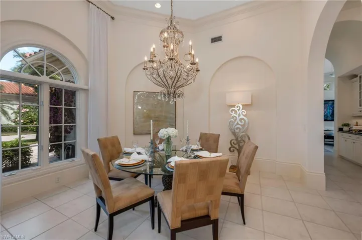 The memorable dinners you and your family will have in this spacious dining room!  To the right and ahead, is the bar and family room.