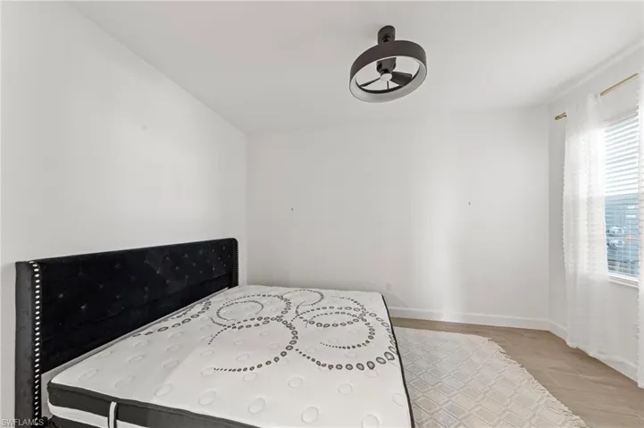 Bedroom featuring light wood-style flooring and baseboards
