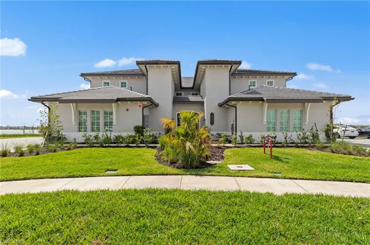 Prairie-style home with stucco siding and a front lawn