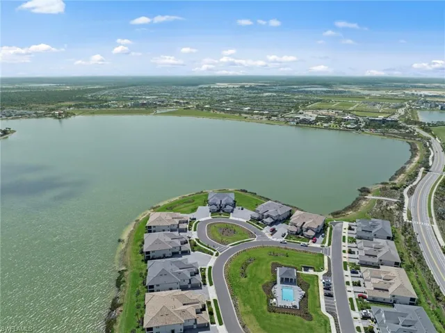 Aerial perspective of suburban area featuring a nearby body of water