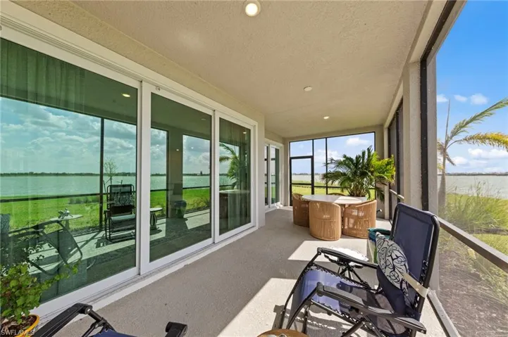Sunroom / solarium featuring a water view, recessed lighting, and a textured ceiling