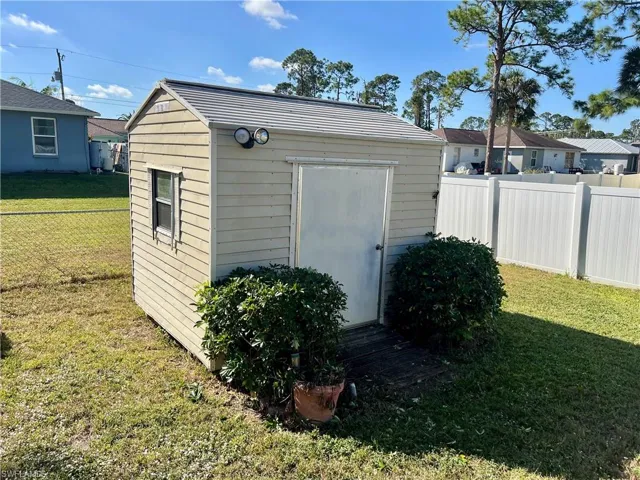 View of storage shed with electric.