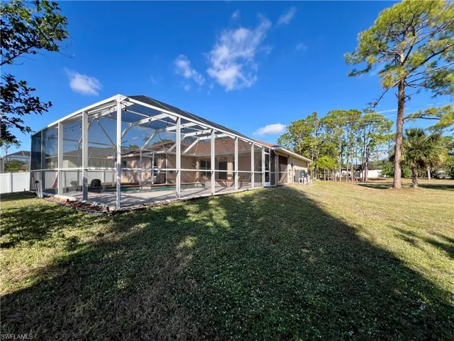 View of yard with a lanai and a swimming pool