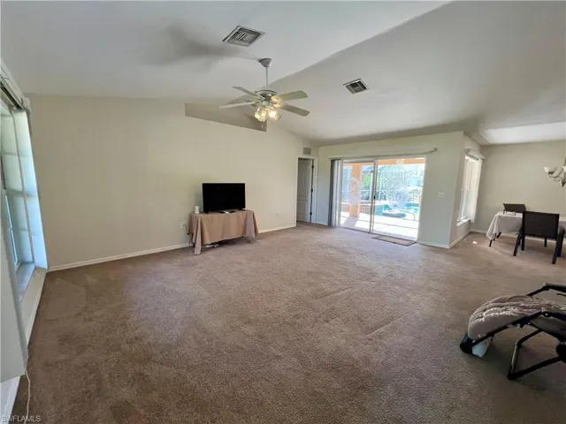 Living room with ceiling fan, and cathedral ceiling