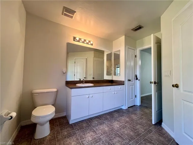 Bathroom featuring vanity and toilet