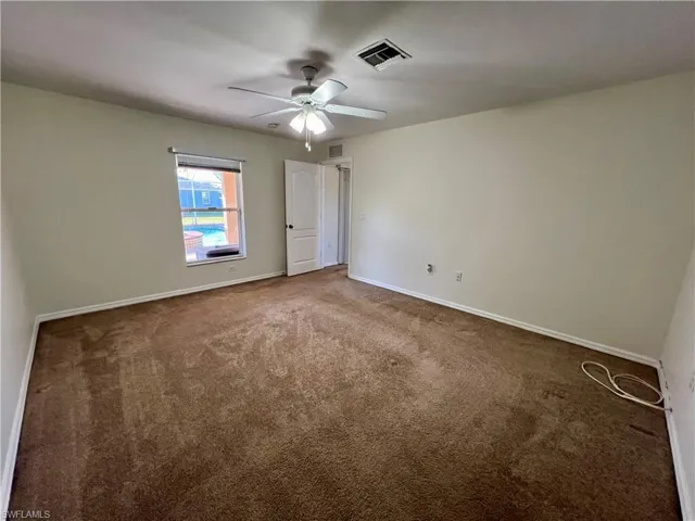 Primary bedroom featuring ceiling fan