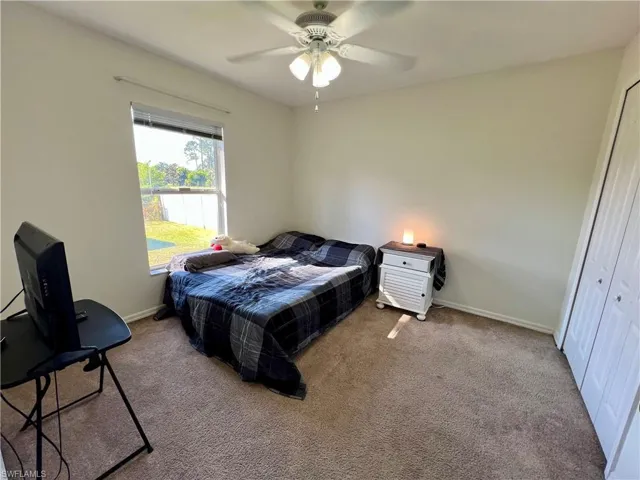 Bedroom featuring ceiling fan and a closet