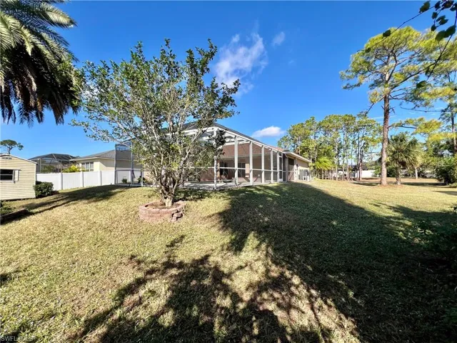 View of yard featuring screen enclosure