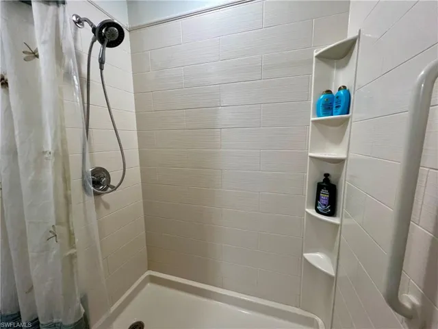 Bathroom featuring curtained walk in  shower