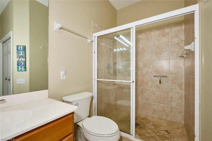 Bathroom featuring vanity and a shower stall