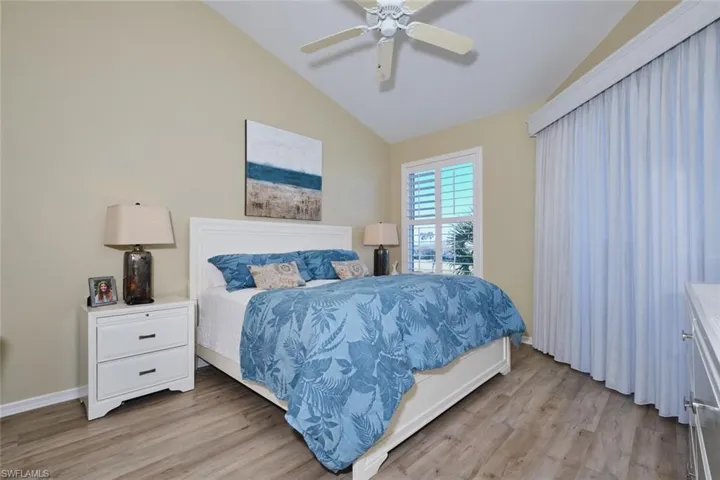 Bedroom featuring lofted ceiling, light wood-type flooring, and ceiling fan