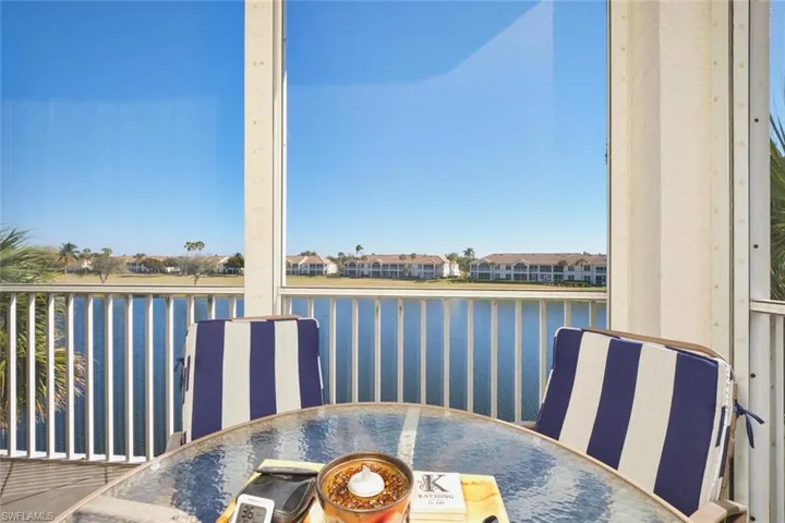 Balcony featuring outdoor dining space and a water view