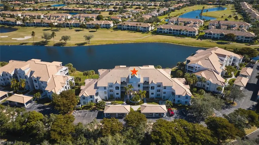 View of property location with a large body of water, a golf club, and nearby suburban area