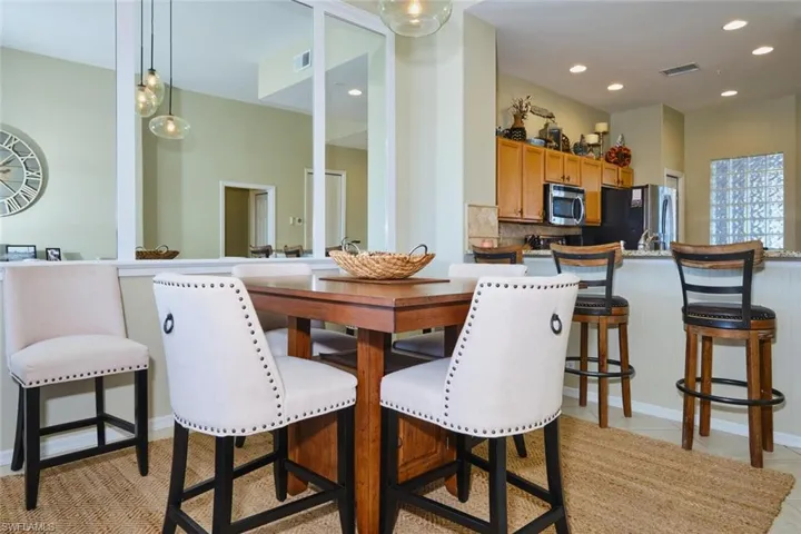 Dining space with recessed lighting and baseboards