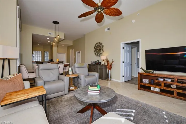 Living area featuring ceiling fan and light tile patterned floors