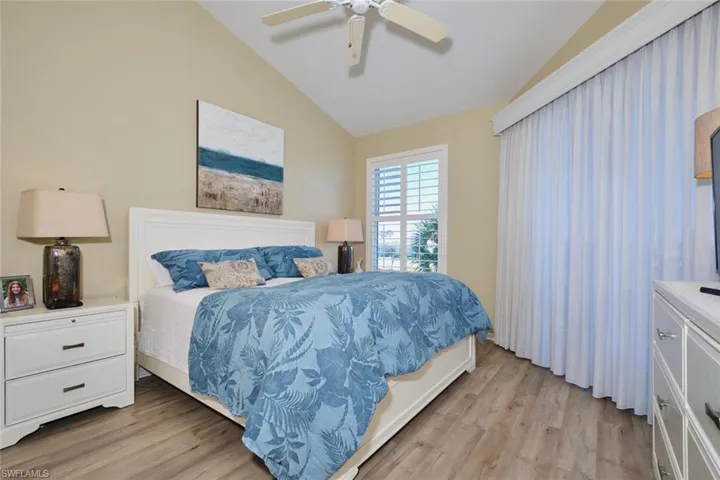 Bedroom featuring light wood-type flooring, lofted ceiling, and ceiling fan