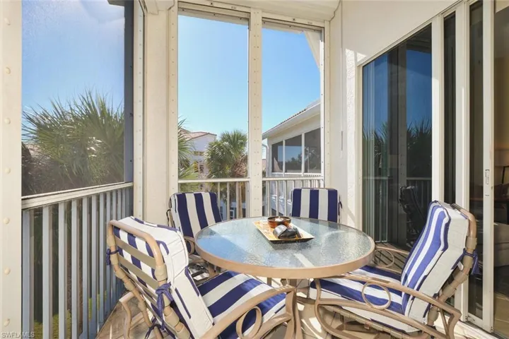Sunroom / solarium with outdoor dining area and a balcony