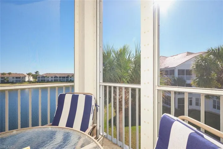 Balcony with a water view and outdoor dining space
