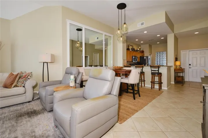 Living room featuring light tile patterned floors and recessed lighting