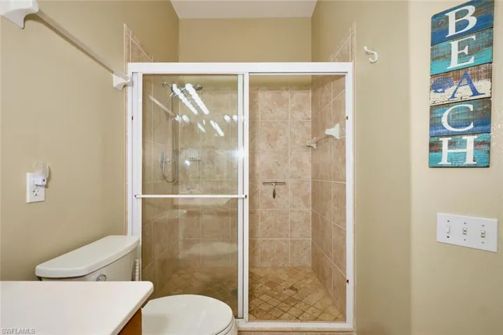 Bathroom featuring vanity and a shower stall