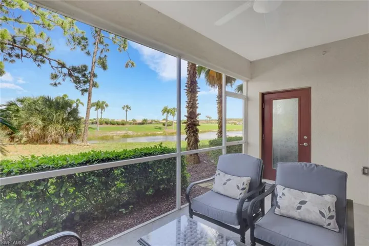 Sunroom featuring a water view and ceiling fan
