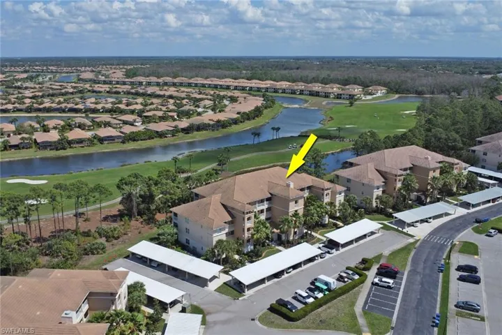 Aerial perspective of suburban area with a golf course and a nearby body of water