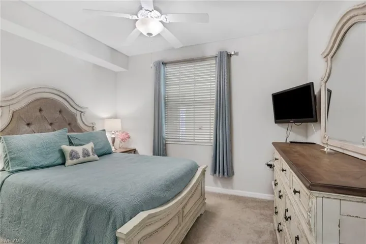 Bedroom featuring a ceiling fan and light carpet