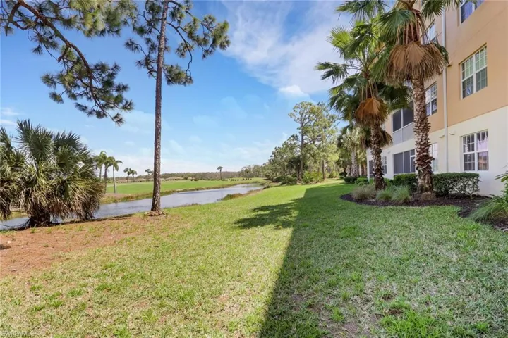View of green lawn featuring a water view