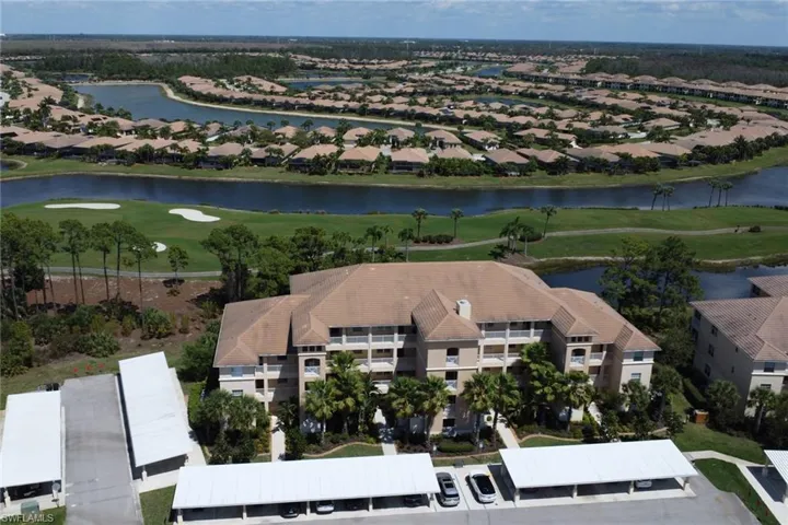 Aerial perspective of suburban area with a large body of water and a local golf course