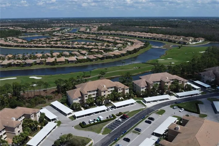 Aerial overview of property's location featuring a golf course and nearby suburban area