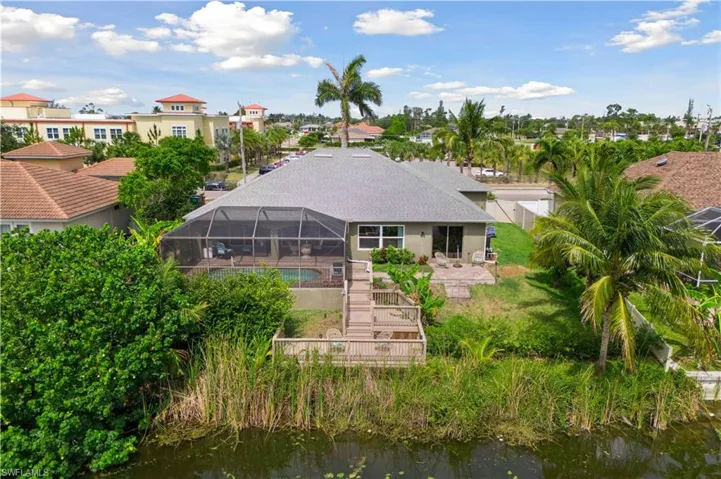The pool stands as a central focal point, its sparkling water reflecting the surrounding landscape, with the lanai and deck leading gracefully toward it.