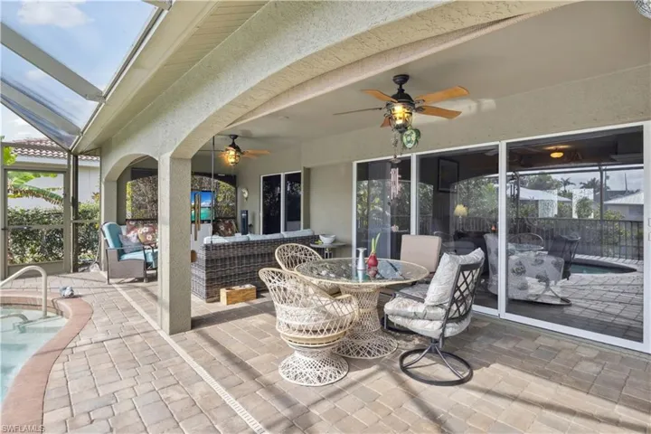 The lanai is a spacious, inviting outdoor space that seamlessly blends with the pool area, offering a perfect spot for relaxation and entertaining.