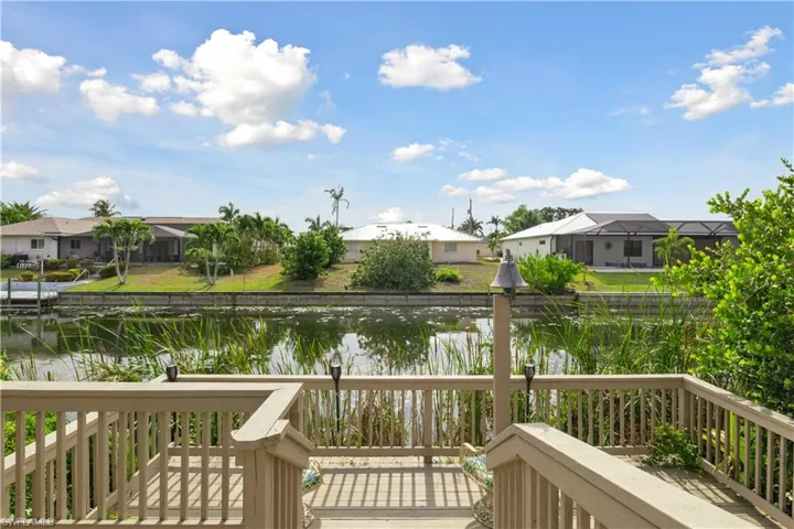 The deck extends gracefully toward the canal, offering a tranquil space to enjoy the water views.