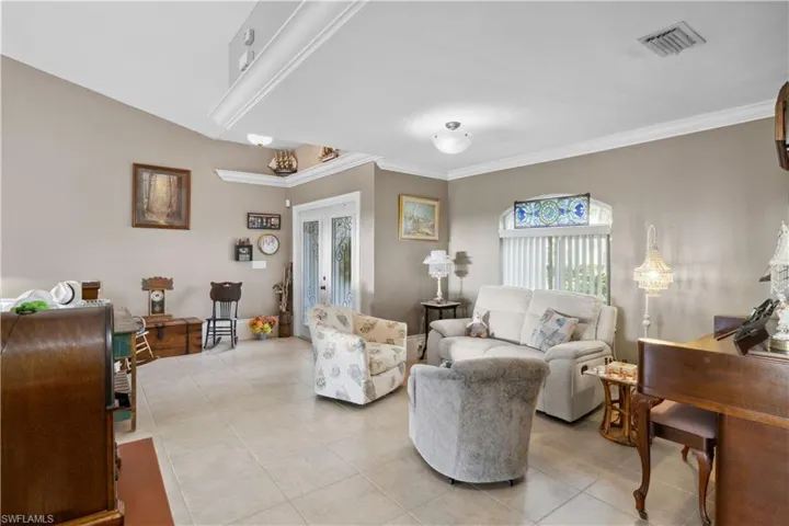 The living room, seamlessly connected to the foyer, is a cozy and stylish space that offers a warm welcome as you step inside.