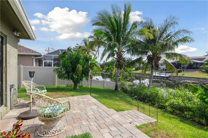 Framed by lush landscaping and serene water views!