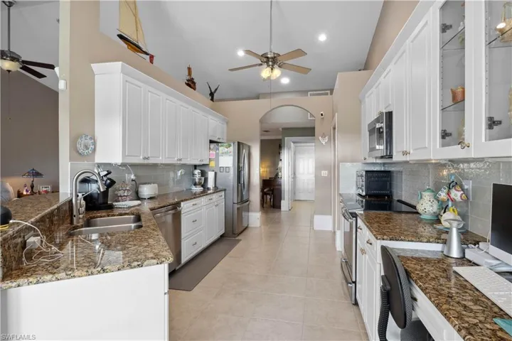 The kitchen is a bright, modern space that combines style and functionality with ease. It features sleek cabinetry, high-end stainless-steel appliances, and granite countertops that offer ample prep space.