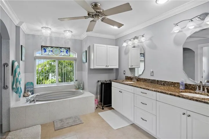 The primary bathroom is a luxurious retreat, complete with a soaking tub, a spacious walk-in shower, and a dual-sink vanity, all exuding a tranquil, spa-like ambiance.
