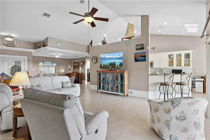 The home is nothing short of stunning—through wide glass doors, you can see the open-concept living, kitchen, and dining areas bathed in natural light.