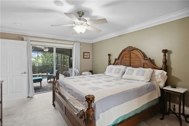 Primary bedroom features is the set of sliding glass doors that open directly to the pool area, offering a seamless indoor-outdoor connection.