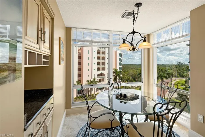 Dining room featuring floor to ceiling windows, a chandelier,