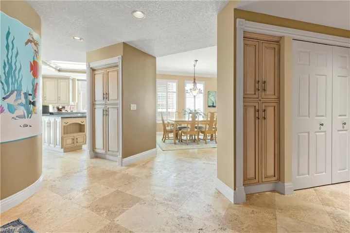 Foyer with a recessed lighting, ornamental molding, and a handpainted decorative wall mural